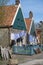 Old-fashioned laundry drying in wind on clotheslines. Walking in historical Dutch fisherman`s village in North-Holland, Enkhuizen