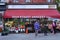 Old fashioned local grocery store with colorful outdoor display of flowers