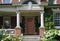 Old fashioned porch surrounded by hydrangea bushes