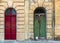 Old fashioned red door and run-down green door in Valletta, Malta