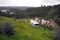 Old-fashioned residential trailer parked on the green besides the ruined rural house, near Belver, Portugal