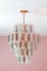 An old-fashioned retro hanging glass chandelier in a pink dining room