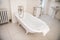 Old fashioned style bathroom with white bathtub.