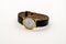 Old fashioned stylish Mens analog wind up wristwatch isolated on a white background