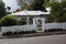 Old, fashioned suburban bungalow home with white picket fence