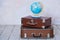 Old fashioned suitcases and global map