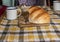 Old fashioned table set for tea with tin cup and loaf of bread