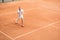 old-fashioned tennis player training with wooden racket and ball