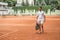 old-fashioned tennis player walking with bag after training on tennis