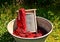 An old fashioned washing trougth filled with dyed and washed strings and ropes of red wool