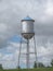 Old fashioned water tower on a hill.