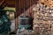 Old fashioned wine press next to pile of logs