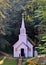 Old fashioned wooden country church in the forest