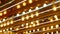 Old fasioned electric lamps blinking and glowing at night. Abstract close up of retro casino decoration shimmering in