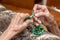 Old female hands holding green praying beads