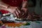 Old female hands at work in the kitchen. Grandma making small meat pie. Cooking process