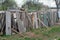 Old fence made of boards and pieces of slate.