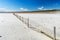 Old fence in a salt lake in Tierra del Fuego in Argentina