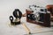 Old film photo camera, magnetic compass and pencil lying on map