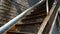 Old fire exit in the city on an abandoned building. The fire escape embraces the facade. The abandoned iron staircase of