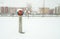 Old fire hydrant for firefighters on the street in the city with snow in the winter season