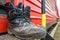 Old firefighter boots on the background of red fire train