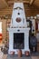 Old fireplace in a wooden cottage with several antique objects