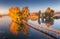 Old fisherman house and wooden pier at sunrise in autumn