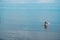 Old fisherman throws nets for fish on the beach