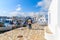 Old fisherman walking along boats in Naoussa fishing port, Paros island, Greece