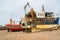 Old fishermans boats and bulldozer on seafront in Hastings old t