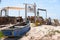 old fishermen\\\'s boats abandoned on dirty beach trash dirt pollution fishermen