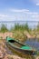 Old fishing boat in a calm water lake during daylight in La Alb