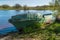 Old fishing boat in the early morning on the shore of the Bayou of lake Ladoga near the city of New Ladoga