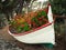 Old fishing boat filled with colorful flowers