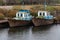 Old fishing boat moored at the pier. Rusty iron ship. Dump on the river or other reservoir. Used and abandoned fishery equipment