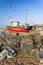 Old Fishing boats and equipment on Hastings beach landscape at d