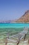 Old fishing bridge in turquoise lagoon