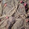 Old fishing nets. Old rope twisted and tied in a bundle on a rough wooden background