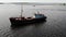 Old fishing ship in a bay on the water. Aerial Drone is rotating circular flight