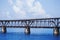 The old Flagler train bridge on s sunny day in the Keys with white puffy clouds.