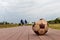 Old football without air on the pavement. Accessories for playing football on the sidewalk near the estate.