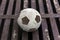 Old football ball on rust iron bar