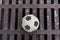 Old football ball on rust iron bar