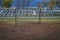 Old football goal against the background of the abandoned stands of the stadium and the blue storm sky