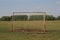 Old football goal for mini football on trampled lawn in forest zone.