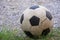 An old football or soccer ball on crushed gravel yard