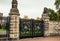 Old forged metal gate in stone colons. Entrance to palace