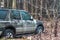 Old forgotten out scrap car that has been abandoned in the woods. Damaged and abandoned vehicle. forest landscape with an