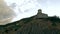 An old fortress with flags on the mountain